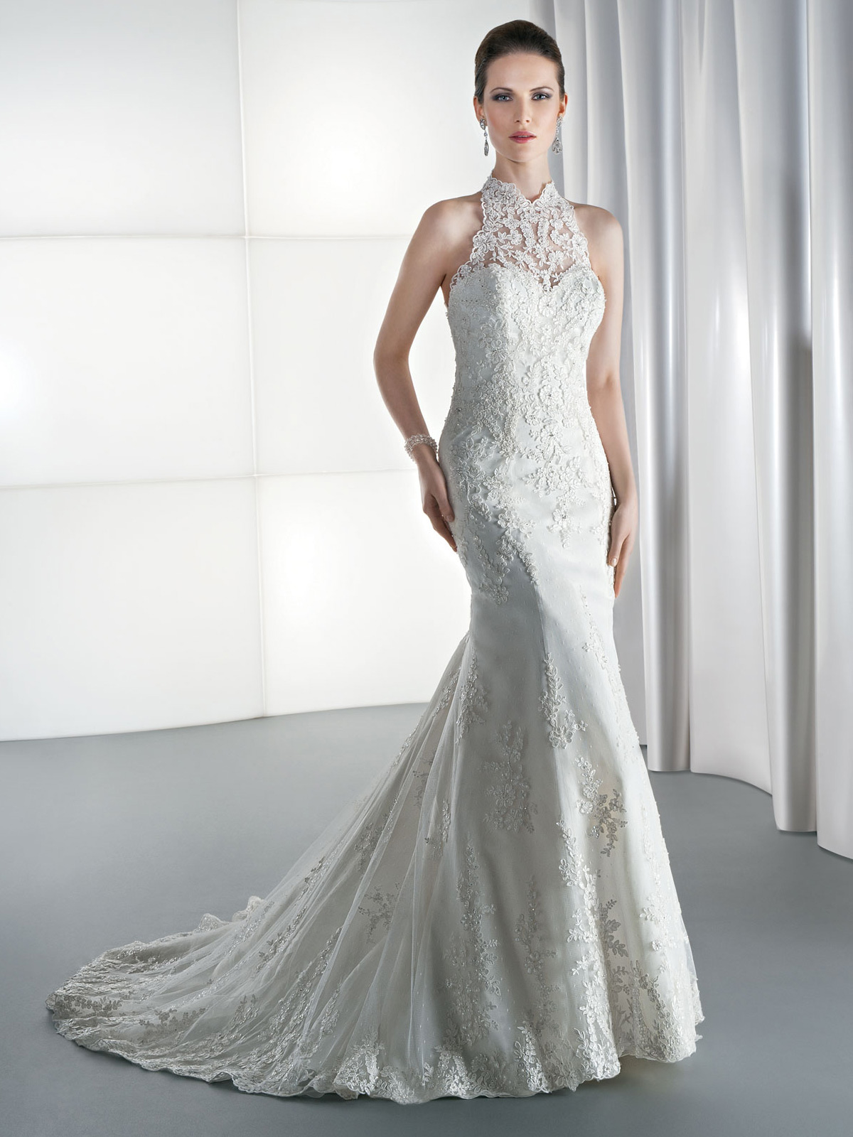 Vestido de Noiva com cava americana e alas de renda nas costas com transparncia, recorte sereia e todo em renda suavemente rebordada, leve cauda.